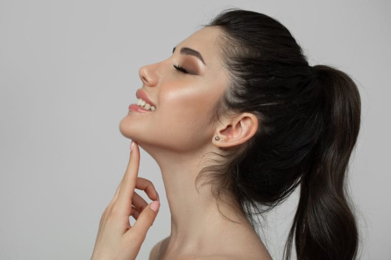 Patient touching her chin after a Kybella treatment.
