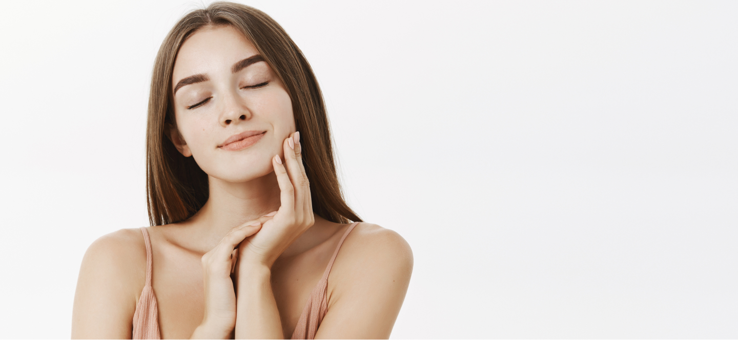 Woman touching her cheeks after receiving Sculptra injection at a medspa.